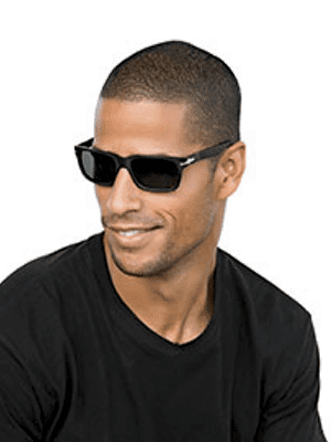 Black male smiling while wearing black plastic designer sunglasses with dark grey lenses Maple Grove Eye Doctors at Pearle Vision