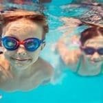 Kids wearing swim goggles . Maple Grove Eye Doctors