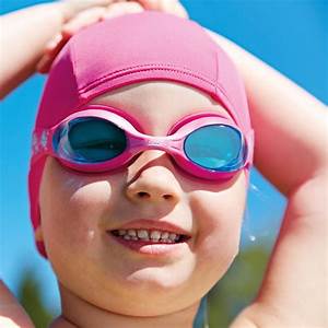 girl wearing pink swim goggles and pink swim cap .