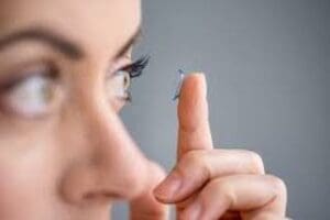 woman with contact lens Maple Grove Eye Doctors at Pearle Vision