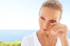 Woman with red eyes - symptoms of eye irritation Maple Grove Eye Doctors