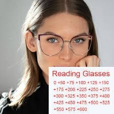 Woman wearing reading glasses with chart showing reading powers. Maple Grove Eye Doctors at Pearle Vision