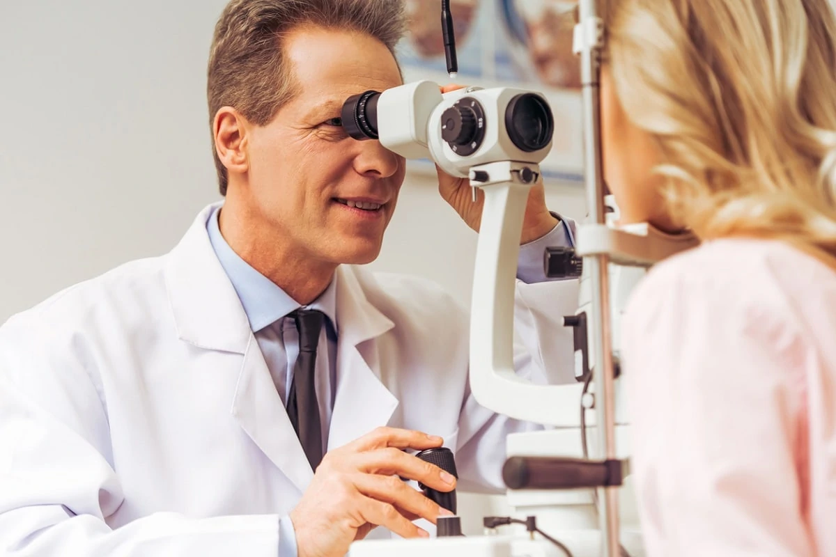 Female patient having LASIK CONSULTATION EYE EXAM with male optometrist MAPLE GROVE EYE DOCTORS AT PEARLE VISION