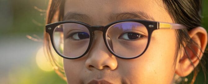 Young Asian girl wearing round plastic frames Maple Grove Eye Doctors at Pearle Vision