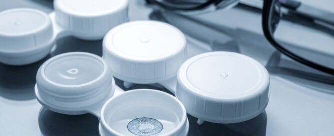 Multifocal contact lens in case beside a pair of eyeglasses from Maple Grove Eye Doctors at Pearle Vision